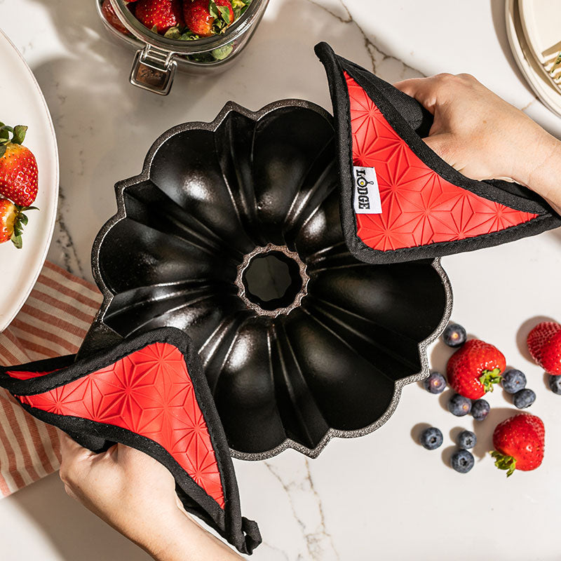 Cast Iron Fluted Cake Pan with Red Potholders - Image 2